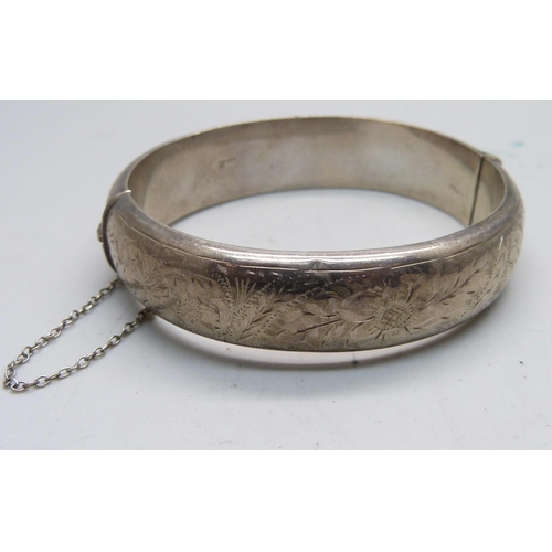 974 - A silver bangle, Birmingham 1964, and a silver ingot pendant, 56g