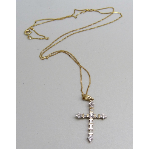 976 - A Gothic style 9ct gold and seventeen diamond cross pendant on a fine 9ct gold chain, 1.7g, chain 45... 