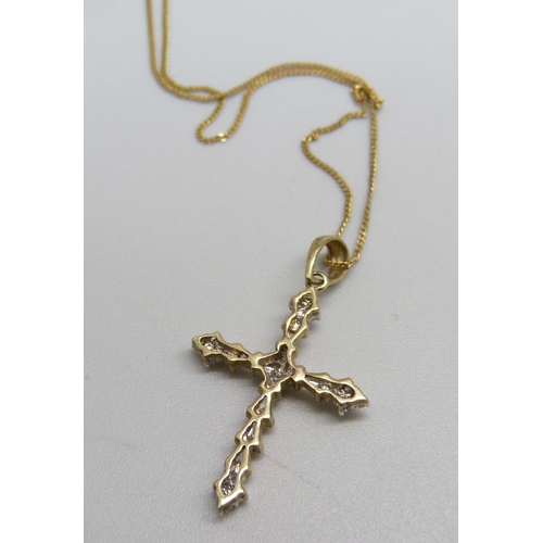 976 - A Gothic style 9ct gold and seventeen diamond cross pendant on a fine 9ct gold chain, 1.7g, chain 45... 