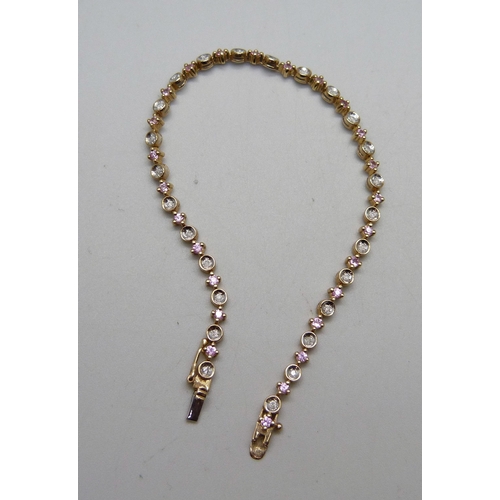 984 - A 9ct gold, pink sapphire and diamond line bracelet, 5.8g