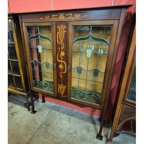 75 - An Art Nouveau inlaid mahogany side cabinet