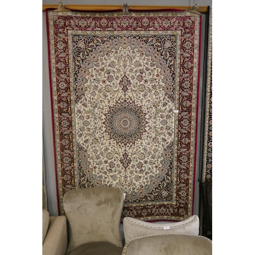 1362 - A red and ivory ground Keshan rug, 190 x 140cm