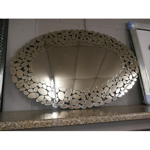 1473 - An oval pebble edged mirror, 120cm x 80cm