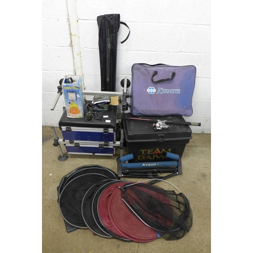 2284 - A quantity of fishing equipment including a Team Diawa fishing box containing various reels, bait bo... 