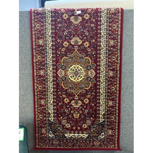 1525 - A red ground Tabriz runner with medallion design, 300 x 80cm