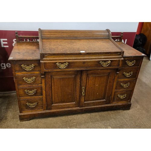 72 - A late Victorian oak tambour roll top bankers desk