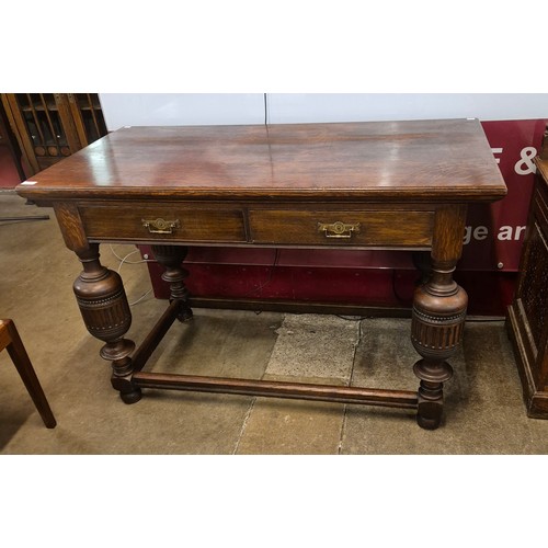 73 - A late Victorian oak two drawer library table