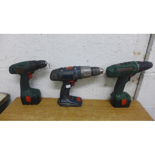 2012 - 3 Bosch cordless drills; Bosch PSR1200 with battery and charger, Bosch PSR12VE-2 and one other hamme... 