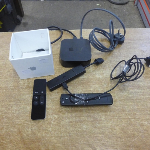 2108 - An Apple TV set top box, model A1513 and an Amazon Fire Stick LY73PR, both with remotes