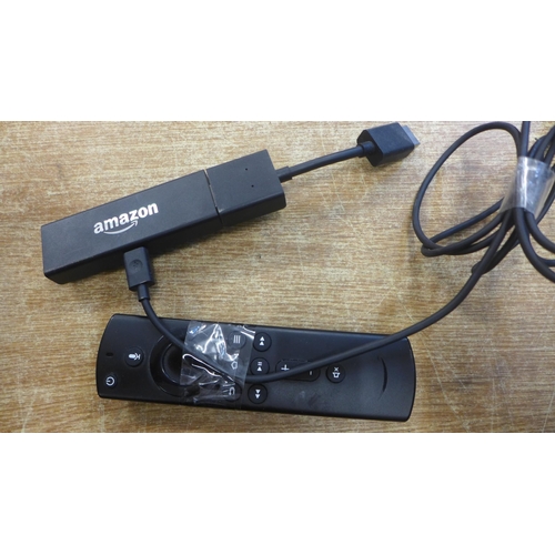 2108 - An Apple TV set top box, model A1513 and an Amazon Fire Stick LY73PR, both with remotes