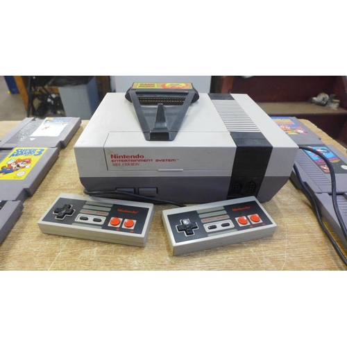 2119 - A Nintendo Entertainment System, NES version, two NES controllers, cables, a Game Genie video game e... 