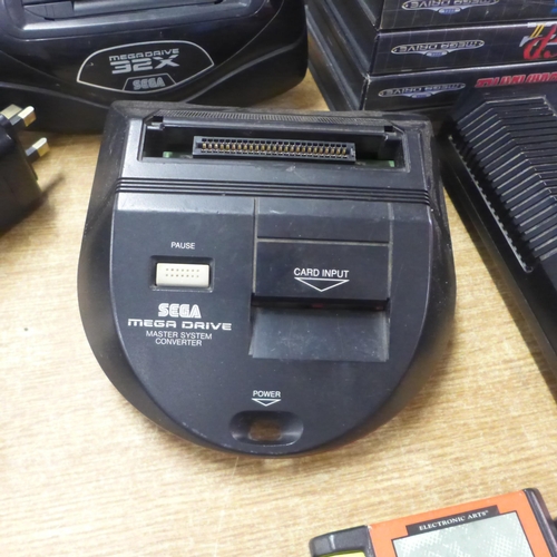 2123 - A Sega Mega Drive console with power and AV cables two control pads, Mega drive 32x convertor, maste... 