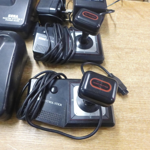 2124 - Two Sega Master System II power base consoles, with power cables, two Sega arcade Control joysticks ... 