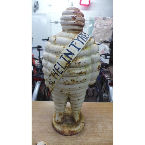 2129 - A cast iron Michelin Tyres 'Michelin Man' statue - approximately 23