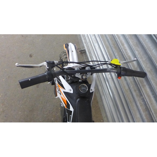 2219 - A Rocket XJE electric off-road mini dirt bike with charger and key - w