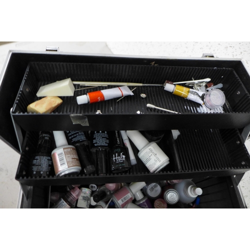 2391 - A Professional aluminum make-up carrying train case containing a quantity of cosmetics including nai... 