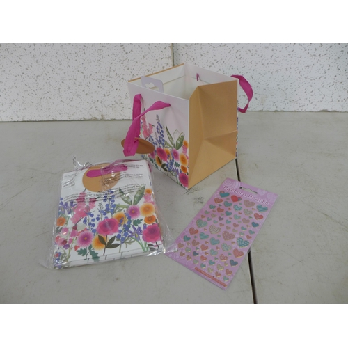 2402 - 7 Boxes of floral gift bags (15 x 17cm) and a box of heart stickers * This lot is subject to VAT