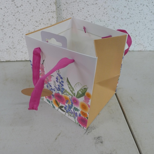 2402 - 7 Boxes of floral gift bags (15 x 17cm) and a box of heart stickers * This lot is subject to VAT