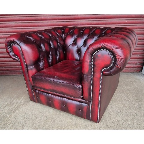 100B - An oxblood red leather Chesterfield three piece lounge suite, comprising, settee, club chair and sto... 