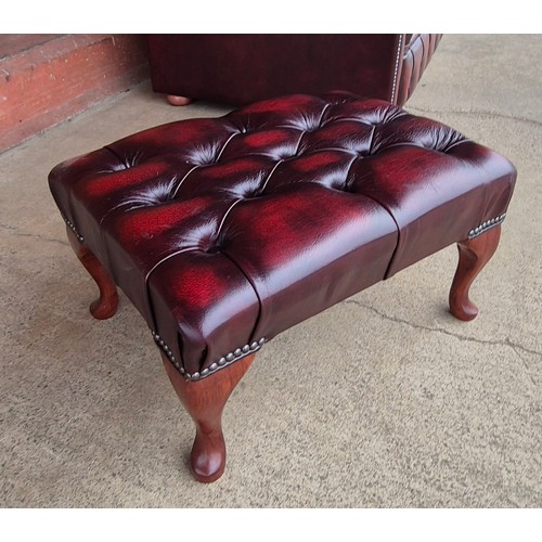 100B - An oxblood red leather Chesterfield three piece lounge suite, comprising, settee, club chair and sto... 