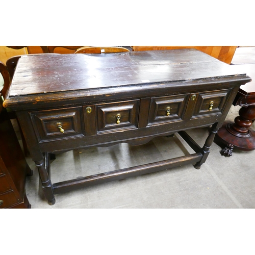 103 - A Jacobean Revival oak geometric moulded two drawer dresser