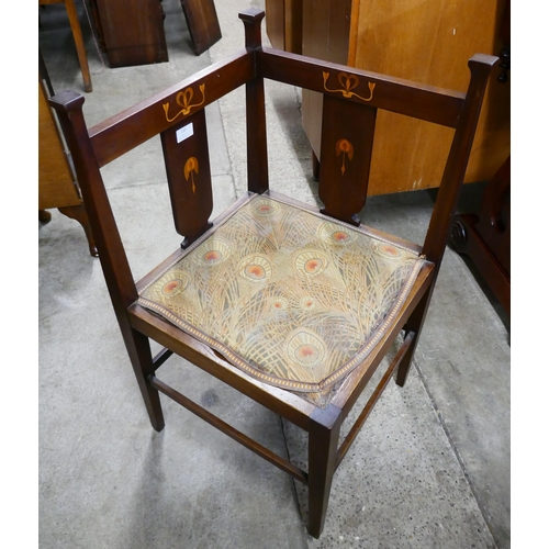 110 - An Arts and Crafts inlaid mahogany corner chair