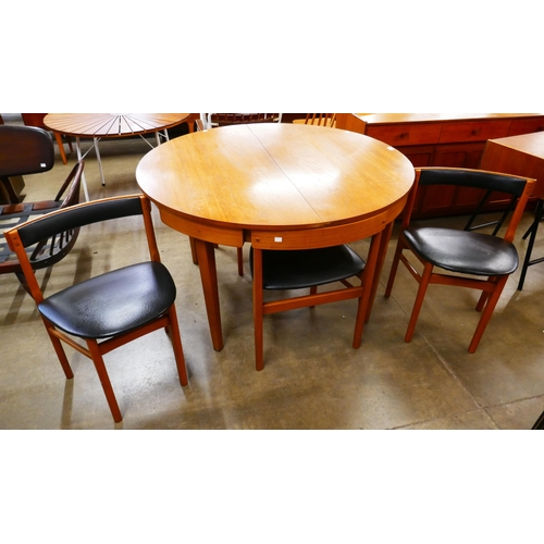 14 - A Nathan teak circular extending table and chairs