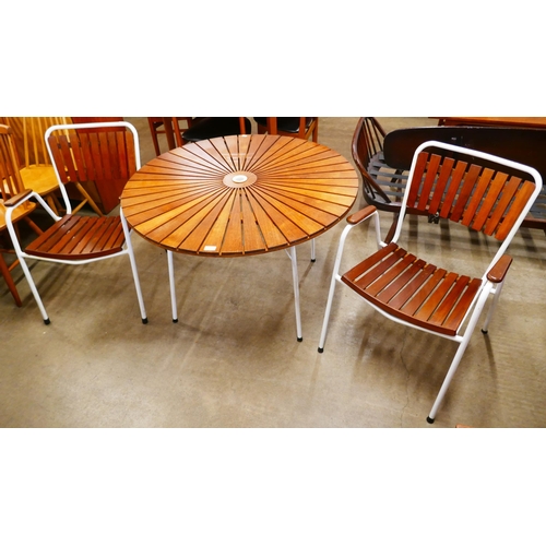 15 - A Danish Daneline teak sunburst and white tubular metal table and two chairs