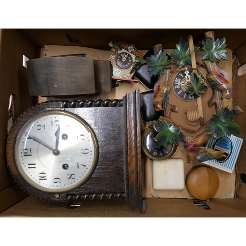 284 - An early 20th Century oak mantel clock, a cuckoo clock, etc.