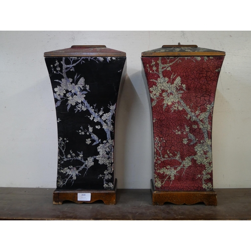 368 - A pair of oriental style black and red lacquered chinoiserie vases and covers