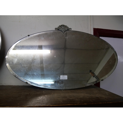 377 - A Art Deco oval chrome and bevelled edge mirror