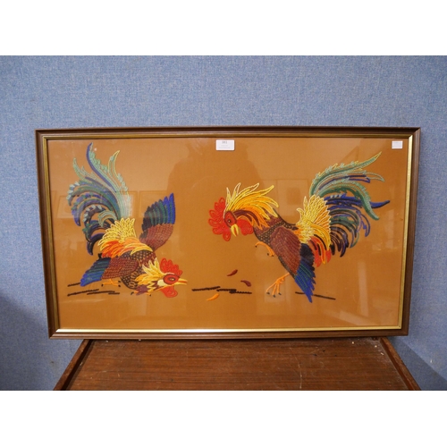 381 - A cock fighting tapestry, framed