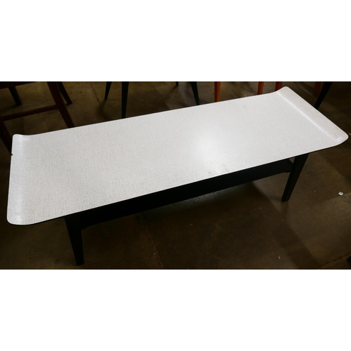 39 - A Formica and black sleigh top coffee table