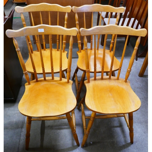 61 - A set of four beech spindle back kitchen chairs