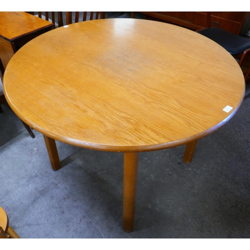 63 - A circular teak dining table