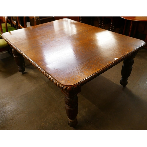 96 - A Victorian carved oak dining table