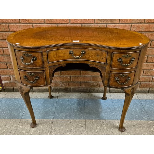 69 - A Queen Anne style burr walnut kidney shaped desk