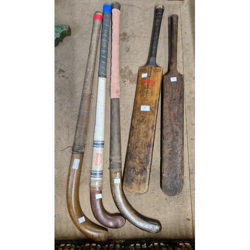 270 - Two vintage cricket bats and three hockey sticks