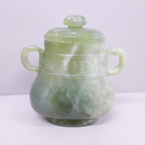 639 - An oriental lidded jade two-handled covered vessel, one handle repaired, 11cm