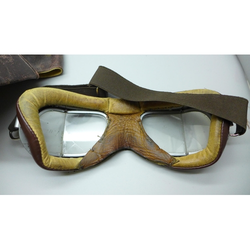 661 - A leather motorcycle riding cap and a pair of goggles