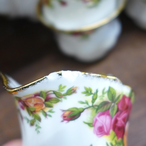 672 - A Royal Albert Old Country Roses tea set, seven cups and saucers, six tea plates, teapot, two creams... 