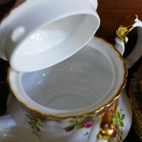 672 - A Royal Albert Old Country Roses tea set, seven cups and saucers, six tea plates, teapot, two creams... 