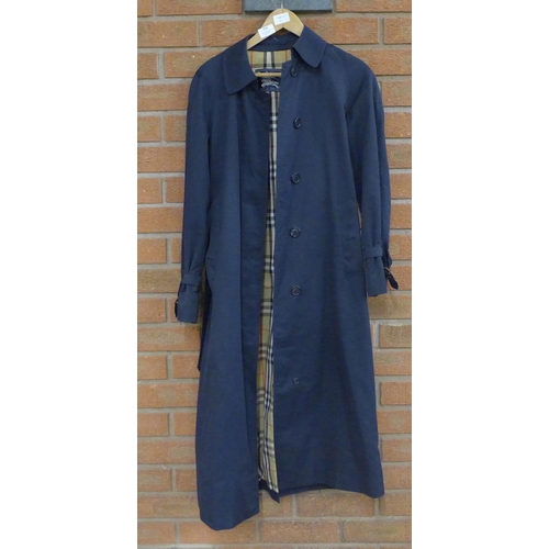 776 - A lady's Burberry trench coat in navy blue, inside tag marked 6 Long