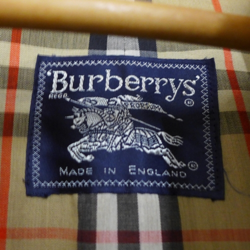 776 - A lady's Burberry trench coat in navy blue, inside tag marked 6 Long