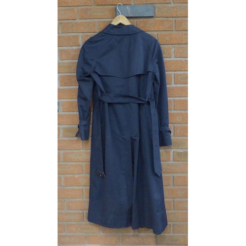 776 - A lady's Burberry trench coat in navy blue, inside tag marked 6 Long