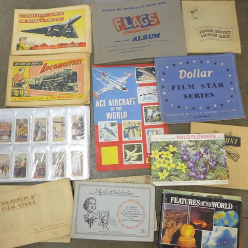 785 - Cigarette cards; a box of cigarette and trade cards in albums and sheets