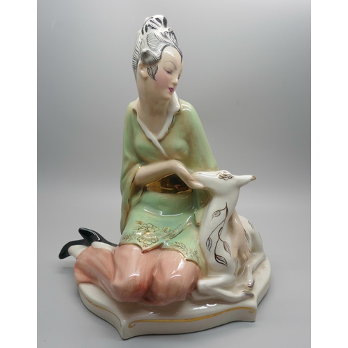 844 - A 1950s Goldscheider figure of a seated Eastern lady stroking a deer, 22cm