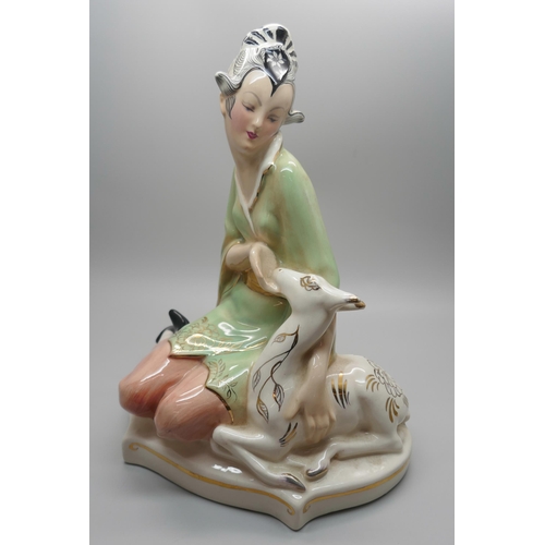 844 - A 1950s Goldscheider figure of a seated Eastern lady stroking a deer, 22cm