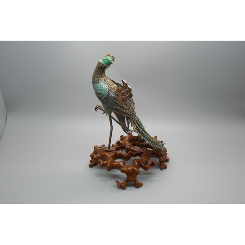 848 - A Chinese silver gilt and enamelled model of a peacock, one amber enamelled piece missing, affixed t... 