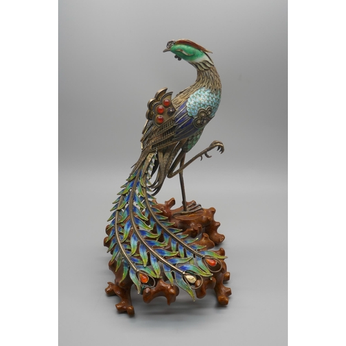 848 - A Chinese silver gilt and enamelled model of a peacock, one amber enamelled piece missing, affixed t... 